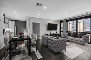 Open concept living and dining space with gray furnishings